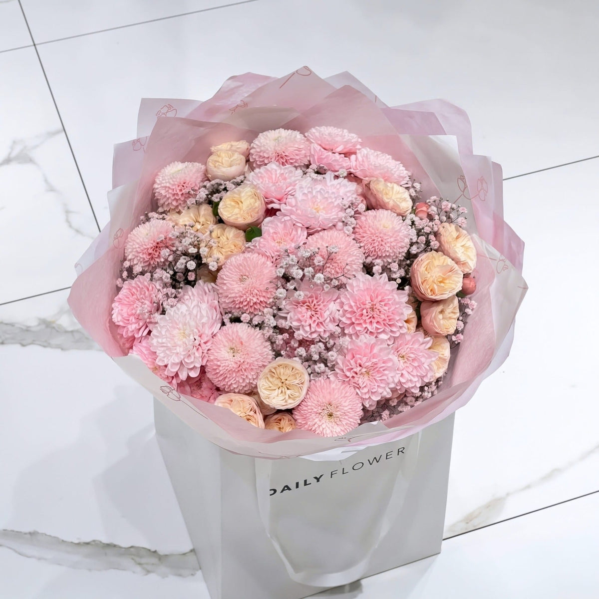 Baby Pink Blush bouquet, size Medium: round bouquet of baby pink chrysanthemums, peach garden roses and blush gypsophila in pink paper, by Daily Flowers