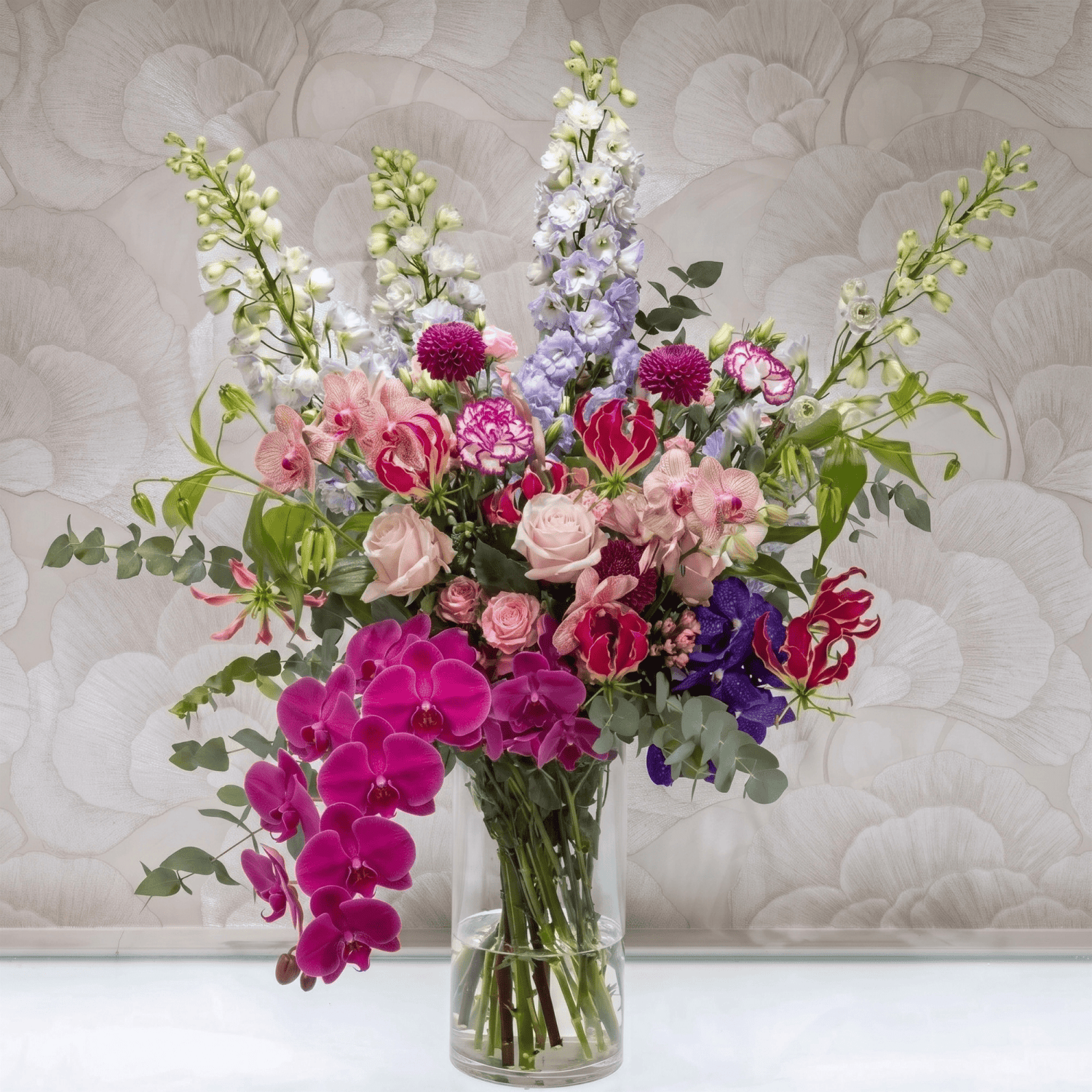 Dazzling Dream bouquet with roses, orchids and eucalyptus by Daily Flowers