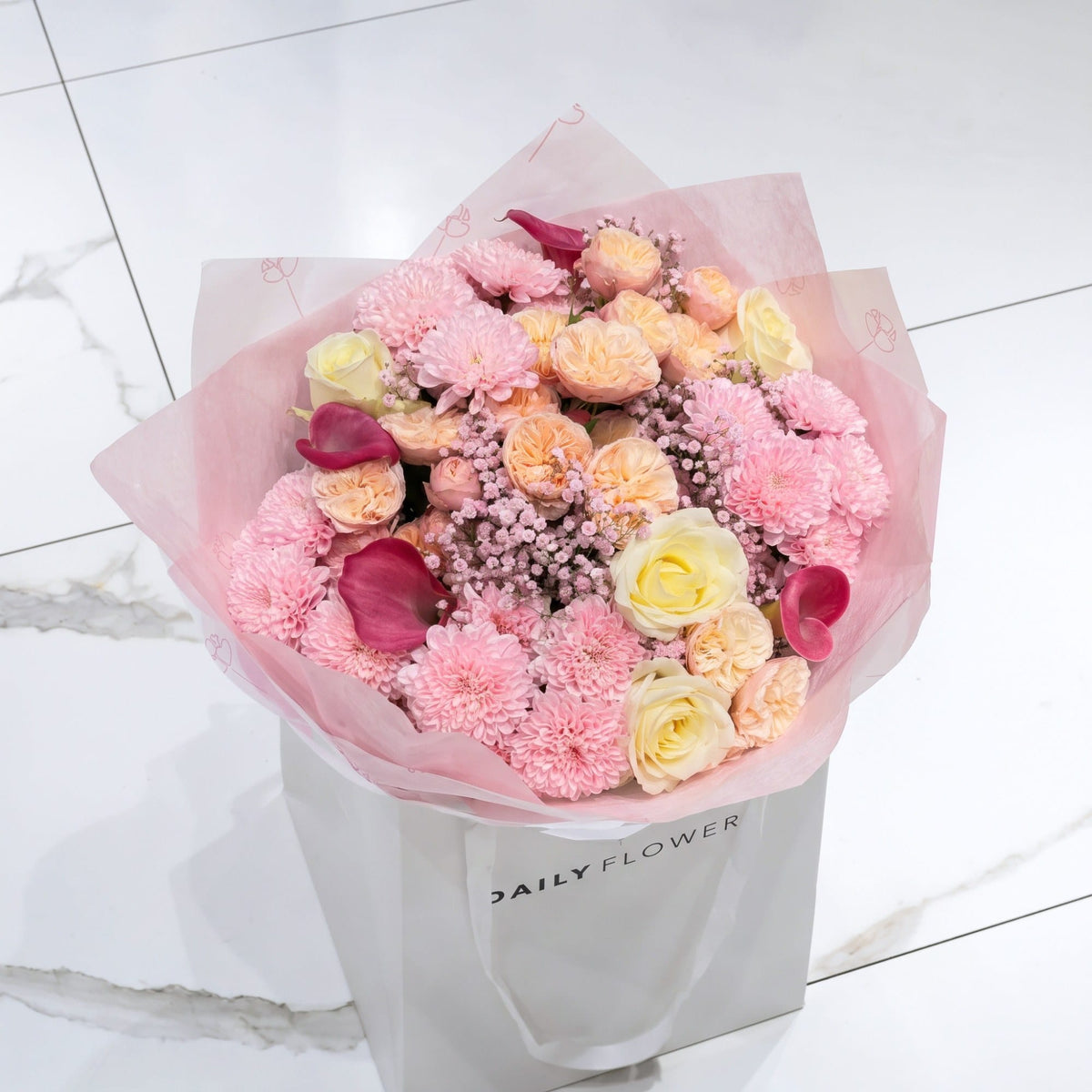 White Blush Romance bouquet, size Medium: peach garden roses, white roses, dark pink callas, pink chrysanthemums and pink gypsophila in pink paper, by Daily Flowers