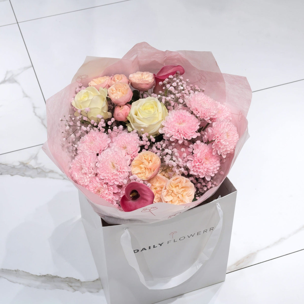 White Blush Romance bouquet, size Small: peach garden roses, white roses, dark pink callas, pink chrysanthemums and pink gypsophila in pink paper, by Daily Flowers