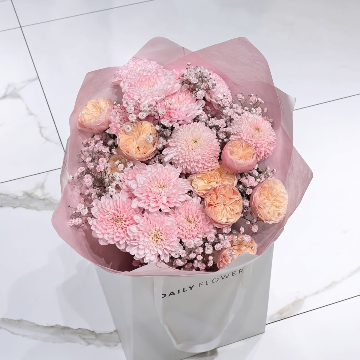 Baby Pink Blush bouquet, size Small: baby pink chrysanthemums, peach garden roses and blush gypsophila wrapped in pink paper, by Daily Flowers