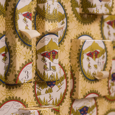 Baobab Advent Calendar Voyage Extraordinaire: close-up of numbered doors with illustrated chalet and ski medallions